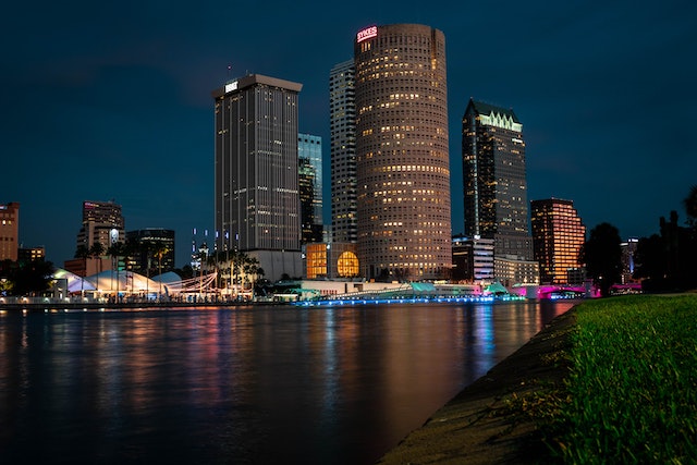 Tampa bay skyline at night with real estate in the background and water in front